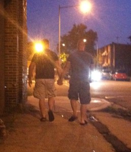 Two men holding hands